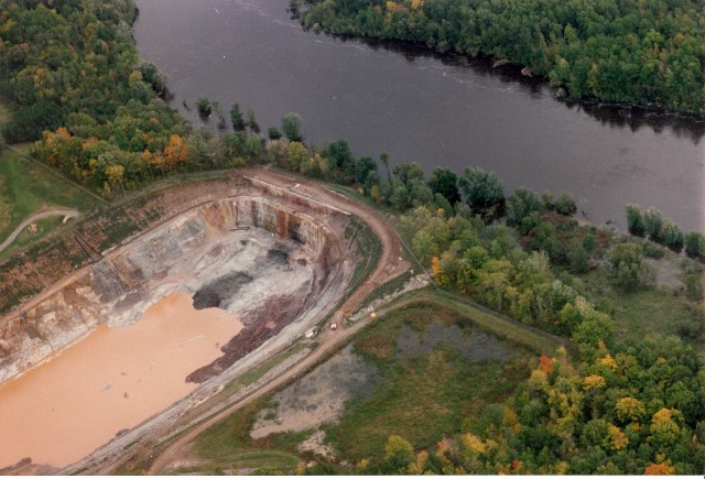 The Flambeau Mine (a Kennecott/Rio Tinto project) operated on the banks of the Flambeau River near Ladysmith, Wisconsin in the mid-1990s. This photo was taken in 1994 when the river flooded during heavy rains and came within 20 horizontal feet and 4 vertical feet of spilling into the mine pit. (Photo by Bob Olsgard of Sarona, WI, September 17, 1994)